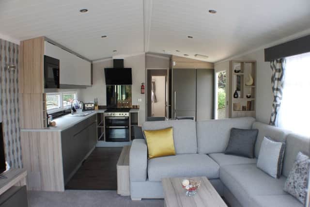 Interior of a static caravan with living room, shower room, kitchen, and double, plus one or two twin rooms means they can sleep up to six