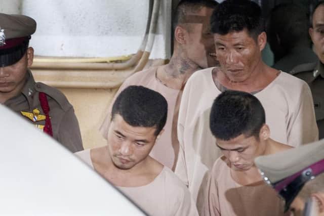 Burmese men Wai Phyo, centre left, and Zaw Lin, centre right, escorted by police officers at the Supreme Court in Bangkok, Thailand, in August 2019. AP Photo/Sakchair Lalit