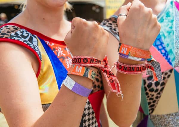 Amy and Lara wearing wristbands after signing up to Second Hand September campaign at Glastonbury 2019.