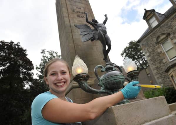 Karolina Allan, a conservator-restorer from Poland, works on Hawick War Memorial, in a demonstration of the merits of freedom of movement in the EU Picture: Stuart Cobley)