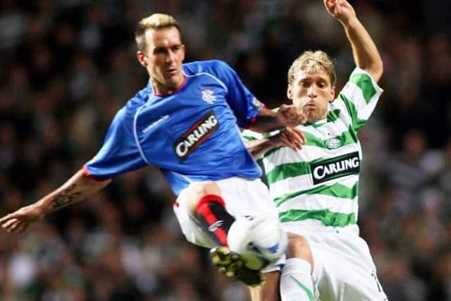 Celtic midfielder Stiliyan Petrov, right, battles for the ball with Rangers' Fernando Ricksen during the CIS Cup quarter-final clash between the two sides in November 2005