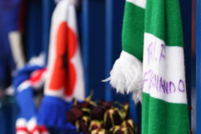 A Celtic scarf tied to the gates at Ibrox as fans leave tributes for Fernando Ricksen