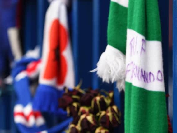 A Celtic scarf tied to the gates at Ibrox as fans leave tributes for Fernando Ricksen