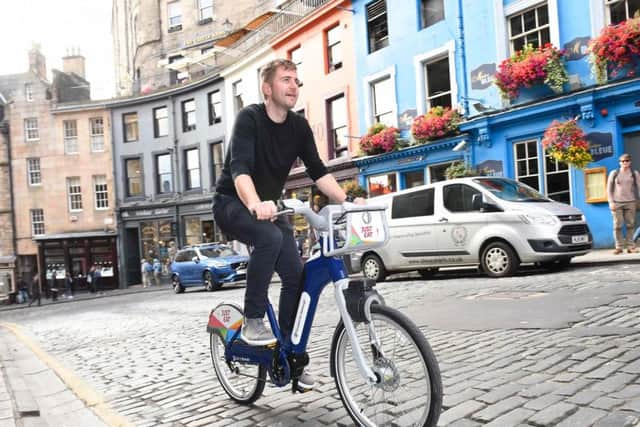The electric bikes enable effortless pedalling up hills like Victoria Street in Edinburgh. Picture: Serco
