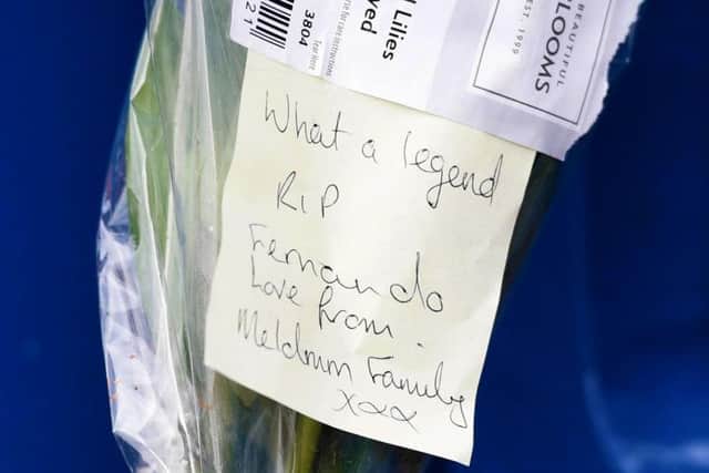 A message from one family tied to a bunch of flowers at Ibrox