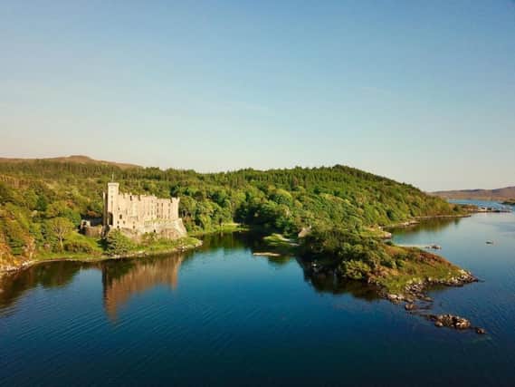 The castle is on the edge of a loch.