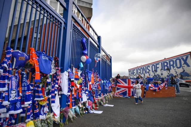 Rangers fans leave tributes at the gates of Ibrox after the death of club idol Fernando Ricksen