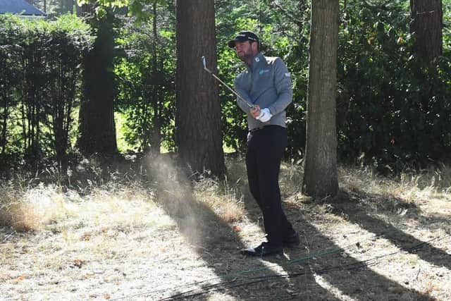 Scotlands Scott Jamieson plays his second shot from the trees on the 15th hole at Wentworth. Picture: Ross Kinnaird/Getty