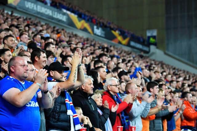 A general view of Rangers fans at Ibrox participating in a minute of applause for Gers legend Fernando Ricksen