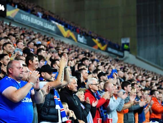 A general view of Rangers fans at Ibrox participating in a minute of applause for Gers legend Fernando Ricksen