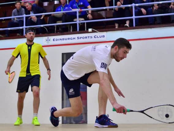 Edinburgh Sports Club's Rory Stewart (white) in action against Newlands' Mike Harris (yellow).