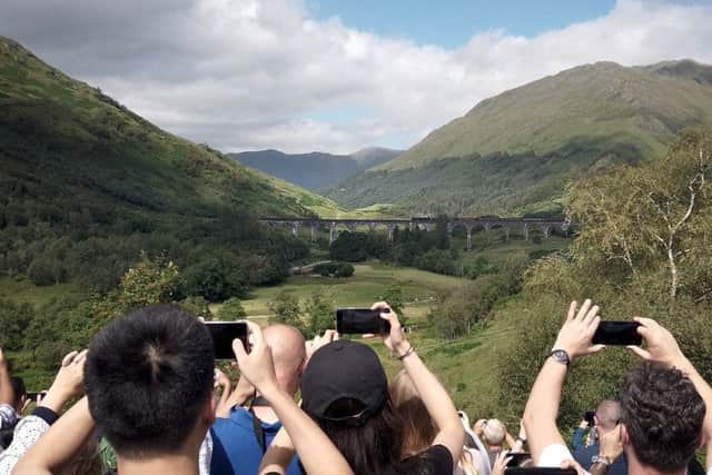 Visitors take pictures of the Glenfinnan Viaduct
