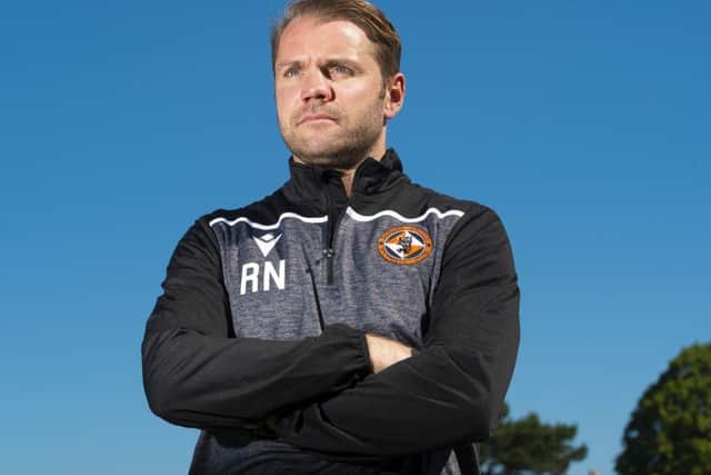 Robbie Neilson has guided his team to the top of the Ladbrokes Championship but he isn't getting carried away. Picture: Ross MacDonald/SNS