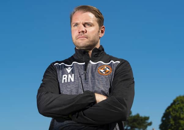 Robbie Neilson has guided his team to the top of the Ladbrokes Championship but he isn't getting carried away. Picture: Ross MacDonald/SNS