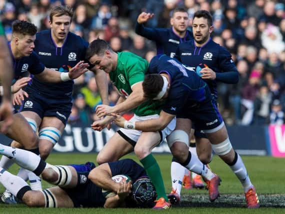 Scotland's Ryan Wilson tackles Ireland's Johnny Sexton during the Six Nations.