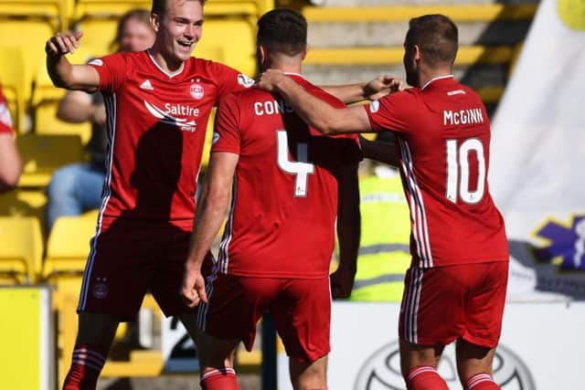 Andrew Considine celebrates his goal with teammates