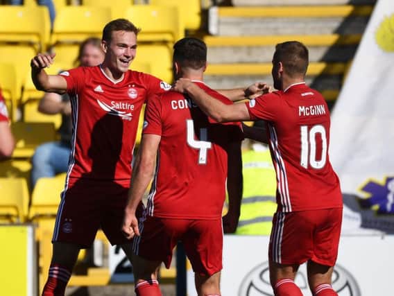Andrew Considine celebrates his goal with teammates