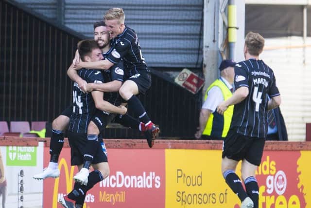 Ryan Dow is mobbed by his team-mates as they celebrate his goal, the second  for Dunfermline. Photograph: Bill Murray/SNS