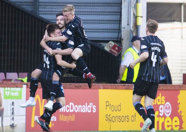 Ryan Dow is mobbed by his team-mates as they celebrate his goal, the second for Dunfermline. Photograph: Bill Murray/SNS