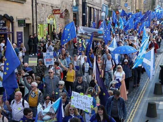 Demonstrators gathered on the Royal Mile before proceeding to a rally held outside the Scottish Parliament at Holyrood.