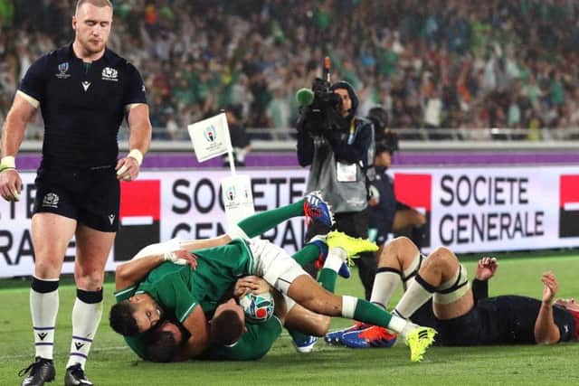 Full-back Stuart Hogg looks despondent as Ireland wing Andrew Conway scores his side's fourth try in a harrowing World Cup opener for Scotland in rain-lashed Yokohama. Picture: Getty Images