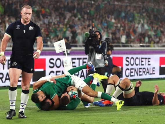 Full-back Stuart Hogg looks despondent as Ireland wing Andrew Conway scores his side's fourth try in a harrowing World Cup opener for Scotland in rain-lashed Yokohama. Picture: Getty Images