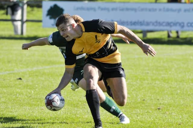 Steven Hamilton touches down for Currie as Hawicks Gareth Welsh tries in vain to stop him. Picture: Ian Rutherford