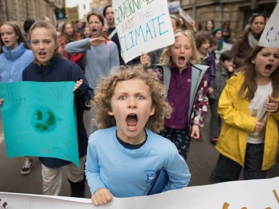 Schoolchildren marching through Cambridge city centre during a climate change protest. Picture: PA