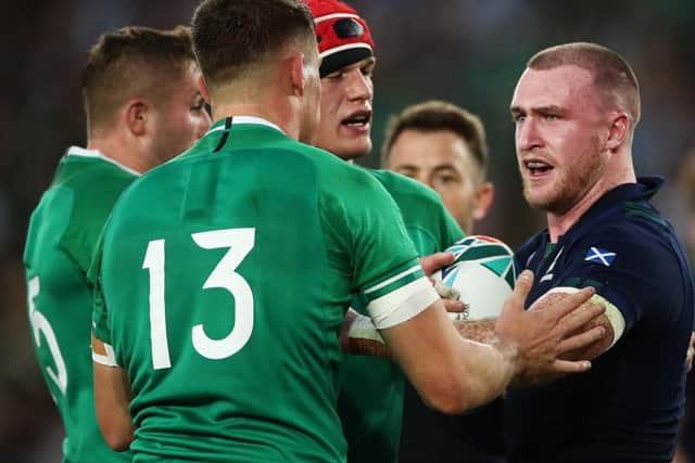 A frustrated Stuart Hogg exchanges words with Ireland centre Garry Ringrose during the 27-3 loss in Yokohama. Picture: Getty Images