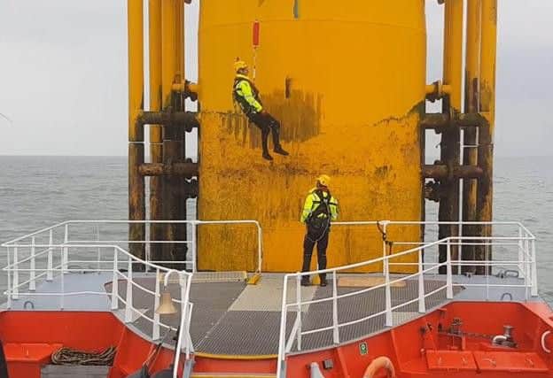 The Gus hoist system compensates for the action of the waves to safely transfer workers from boats on to offshore wind turbines