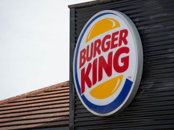 Greenpeace climbers dropped two 10 by 6 metre banners reading Fast Food Fries Forests and Burger King Flame Grilling the Amazon over the building. Picture: PA