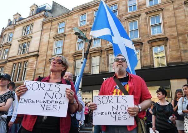 Pro-independence campaigners protest against the selection of Boris Johnson as Prime Minister outside the Glasgow Royal Concert Hall. Picture: John Devlin