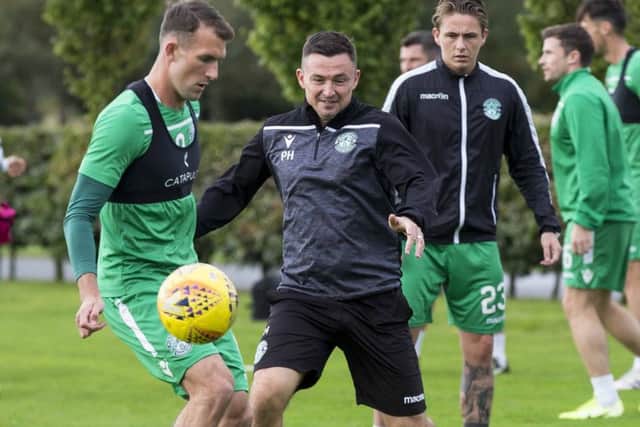 Hibernian boss Paul Heckingbottom in the thick of it during training. Picture: Bruce White/SNS