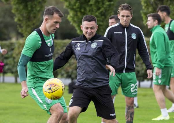 Hibernian boss Paul Heckingbottom in the thick of it during training. Picture: Bruce White/SNS