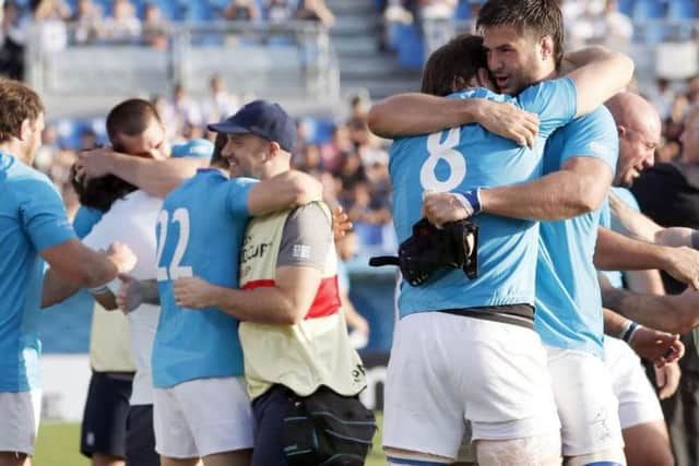Uruguay's players celebrate a famous win over Fiji