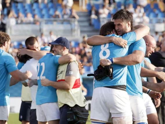 Uruguay's players celebrate a famous win over Fiji