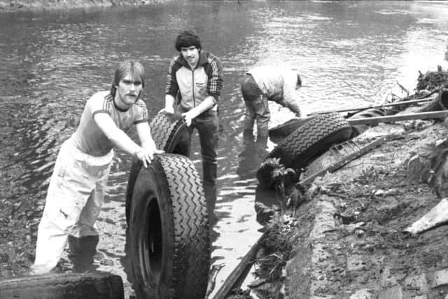 Teenagers helping to clean up the Water of Leith remove abandoned tyres from the river during Operation Riverbank in May 1983.