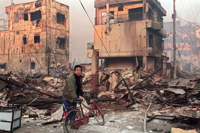 A Kobe resident surveys the devastation in the aftermath of the 1995 earthquake. Picture: Toru Yamanaka/AFP/Getty