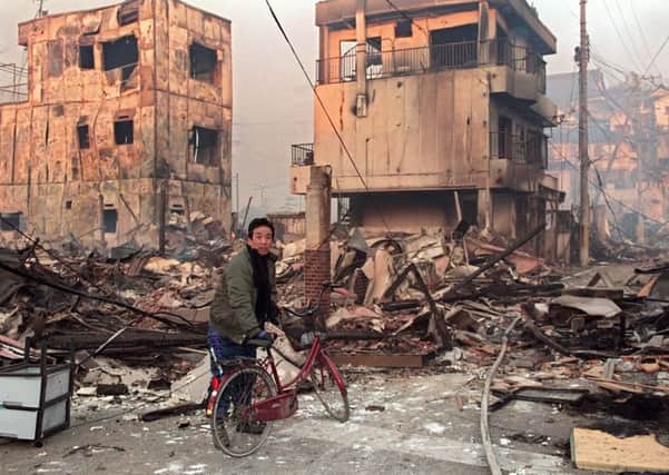 A Kobe resident surveys the devastation in the aftermath of the 1995 earthquake. Picture: Toru Yamanaka/AFP/Getty
