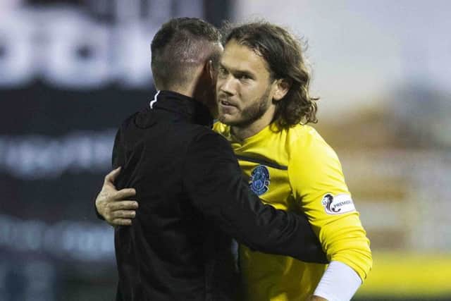 Chris Maxwell gets a hug from manager Paul Heckingbottom after his penalty heroics. Picture: SNS.