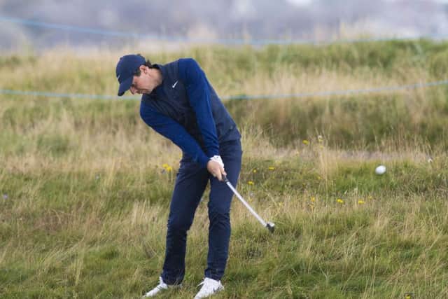 Rory McIlroy plays out of the rough at Carnoustie yesterday. Picture: Ross Parker/SNS