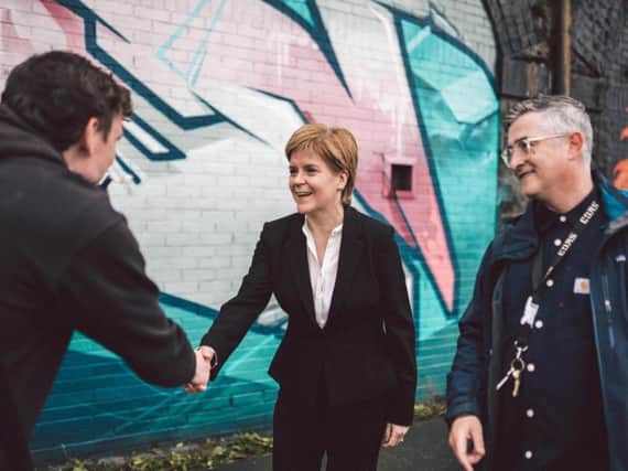 First Minister Nicola Sturgeon visited the SWG3 Yardworks Railway Arch project for a lesson in graffiti art. Picture: PA