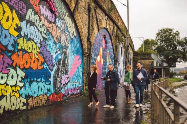 First Minister Nicola Sturgeon walking the 200 metres stretch of new murals with studio director Gaz Mac and SWG3's founder Andrew Fleming-Brown. Picture: PA