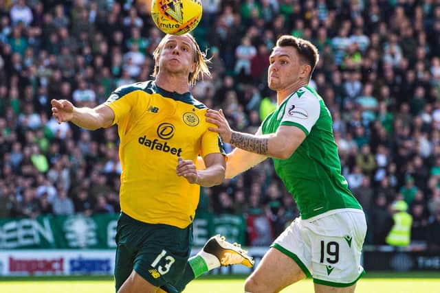Celtic and Hibs players battle for the ball.