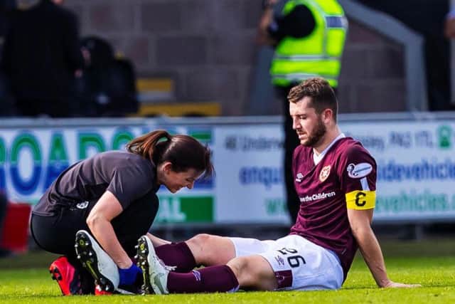 Craig Halkett receives medical attention before being substituted.