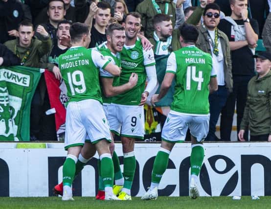 Christian Doidge (No 9) celebrates with team-mates after Kristoffer Ajer turned in his cut-back to give Hibs an early lead against Celtic on Saturday. Picture: Bill Murray/SNS
