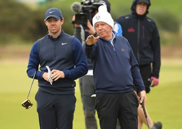 Rory McIlroy lines up a putt with dad Gerry on the ninth hole in the final round of the Alfred Dunhill Links Championship at The Old Course. Picture: Ross Kinnaird/Getty