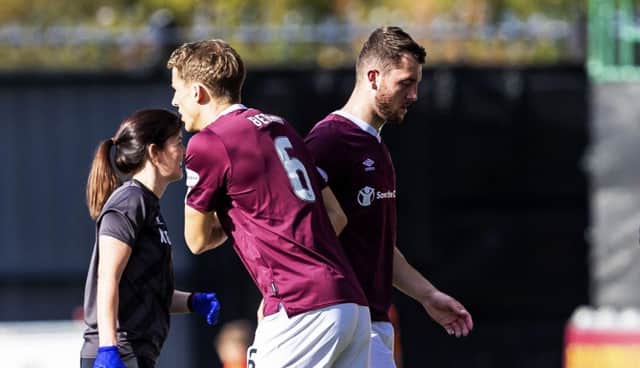 Hearts defender Craig Halkett is replaced by Christophe Berra after suffering a knee injury against St Mirren. Picture: Roddy Scott/SNS