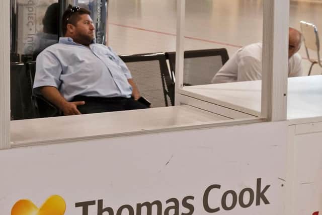A worker at a Thomas Cook travel desk