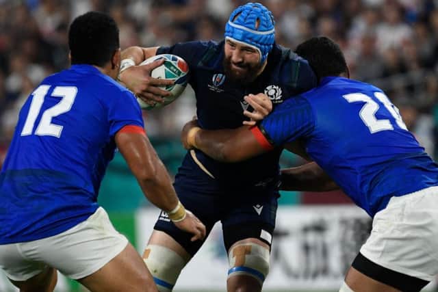 Scotland's No 8 Blade Thomson is tackled by Samoa's Josh Tyrell and Henry Taefu. Picture: AFP/Getty Images